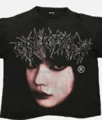 Billionaire Studios Cute Girl Face Logo Tee Black front view Close-up of Cute Girl Face logo on black t-shirt Unisex black streetwear t-shirt styled with jeans Billionaire Studios black tee outfit idea Model wearing Billionaire Studios Cute Girl Face Logo Tee