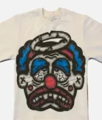Billionaire Studios Sad Jocker Face Blue Logo Tee Cream front view Close-up of Sad Jocker face blue logo on Billionaire Studios tee Side profile of cream-colored Billionaire Studios graphic t-shirt Model wearing Billionaire Studios Sad Jocker Face Blue Logo Tee Cream