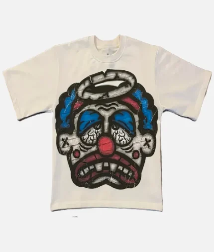 Billionaire Studios Sad Jocker Face Blue Logo Tee Cream front view Close-up of Sad Jocker face blue logo on Billionaire Studios tee Side profile of cream-colored Billionaire Studios graphic t-shirt Model wearing Billionaire Studios Sad Jocker Face Blue Logo Tee Cream